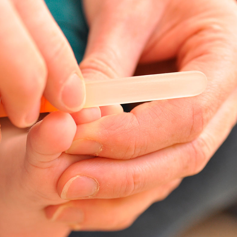 Closeup of baby having toe nails filed